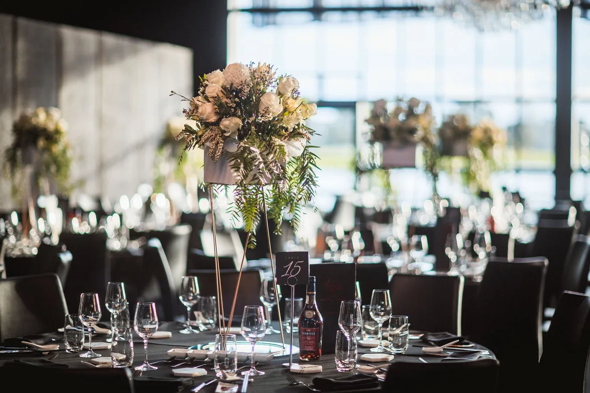 Tall wildflower and rose centrepiece at a moody dark reception